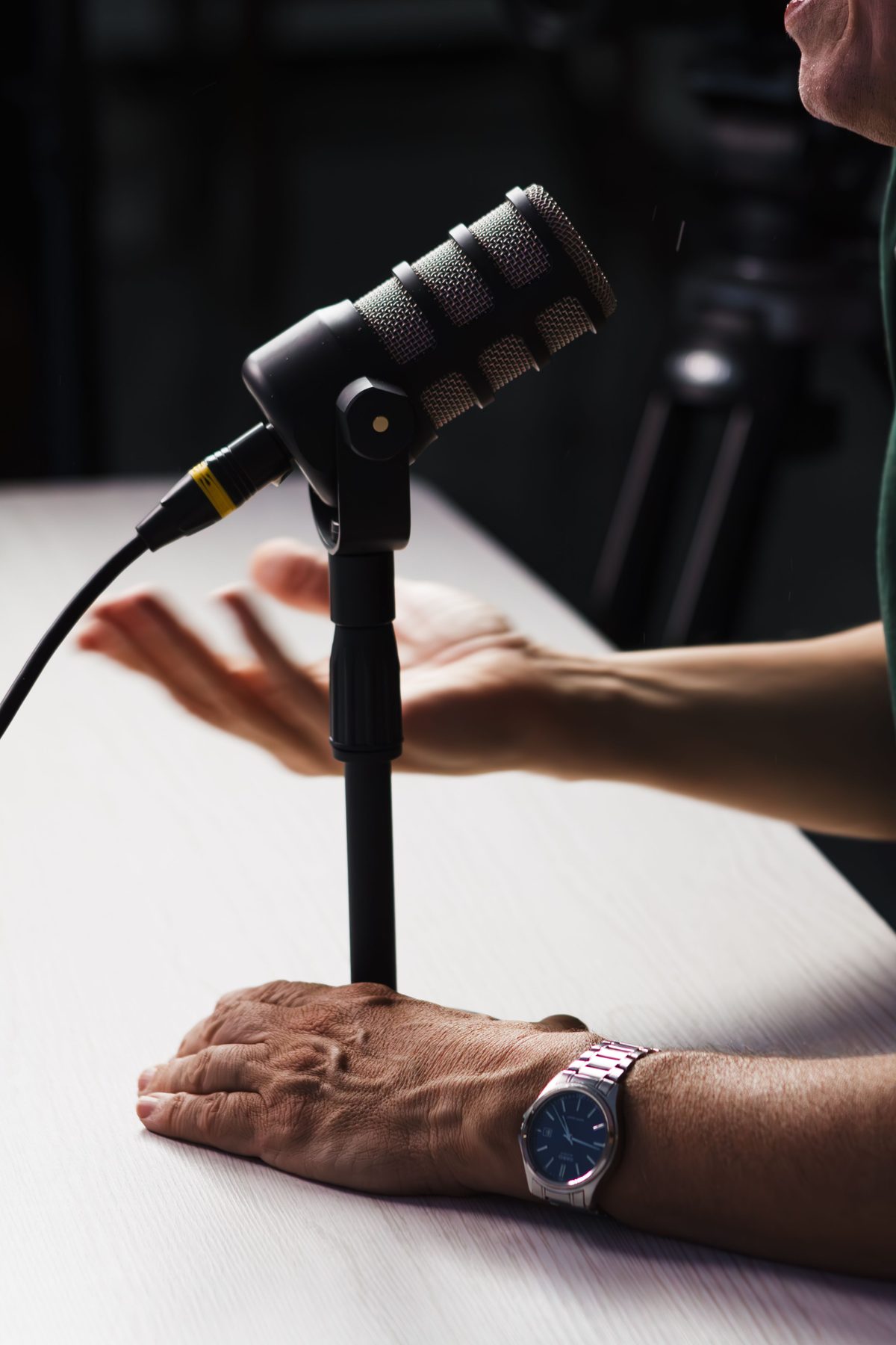 A guest talking beside a microphone on a stand