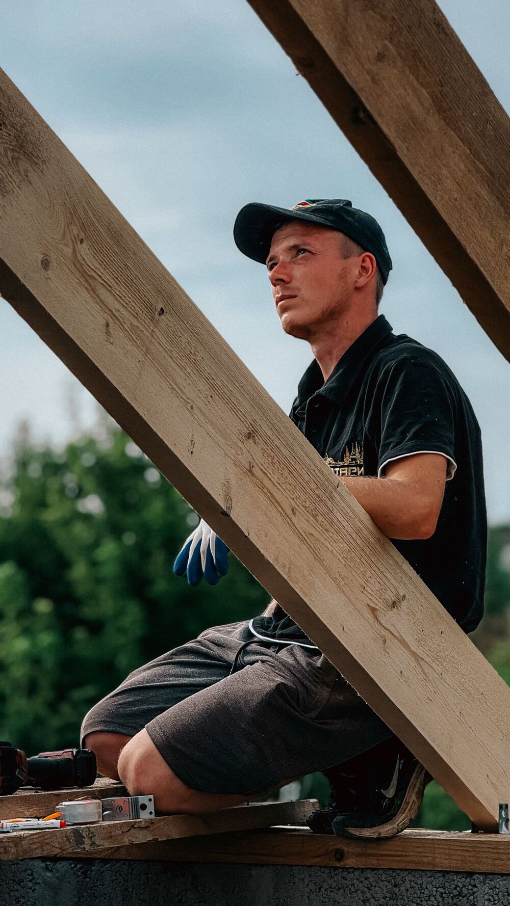 A roofer on a timber roof frame