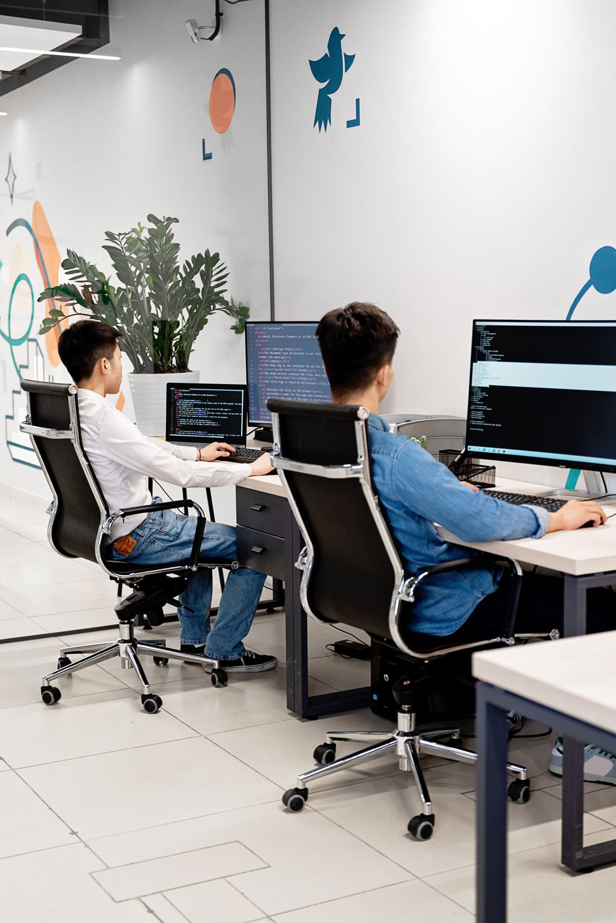 People working at computers in a bright, modern office
