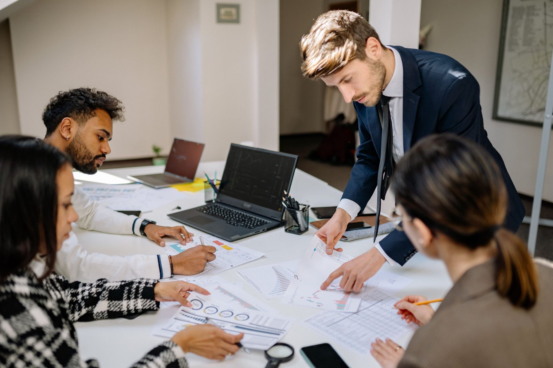 Students and a tutor working together around a table
