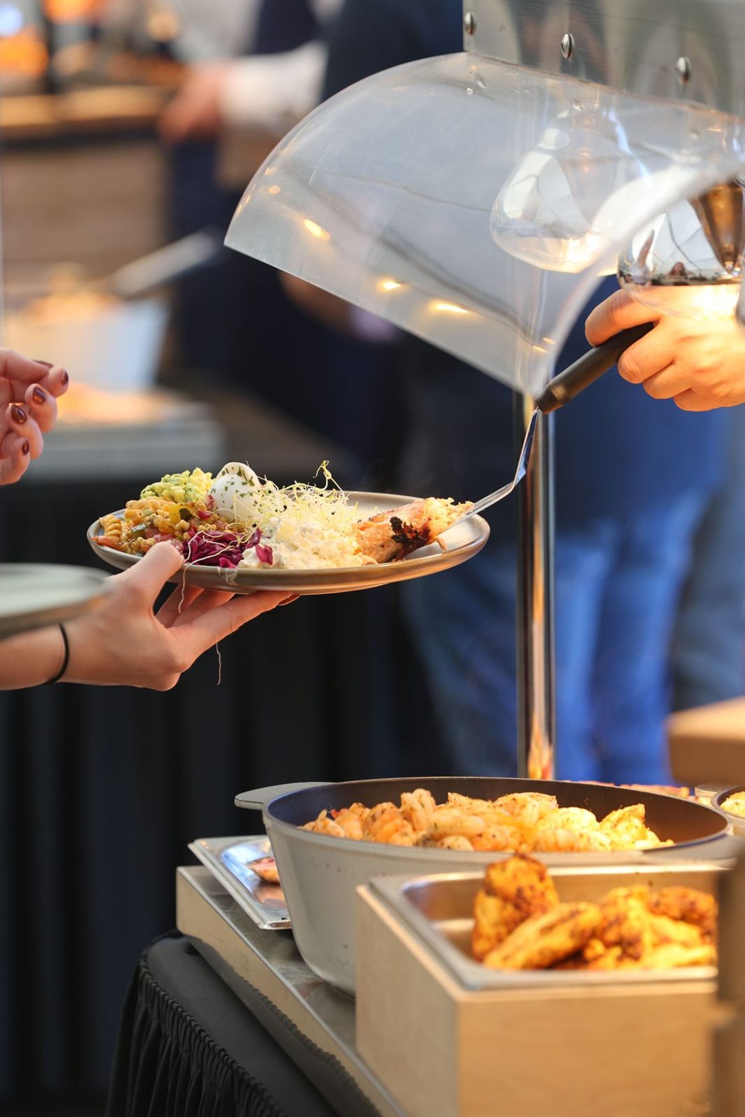 A wedding canape being served from a silver dome