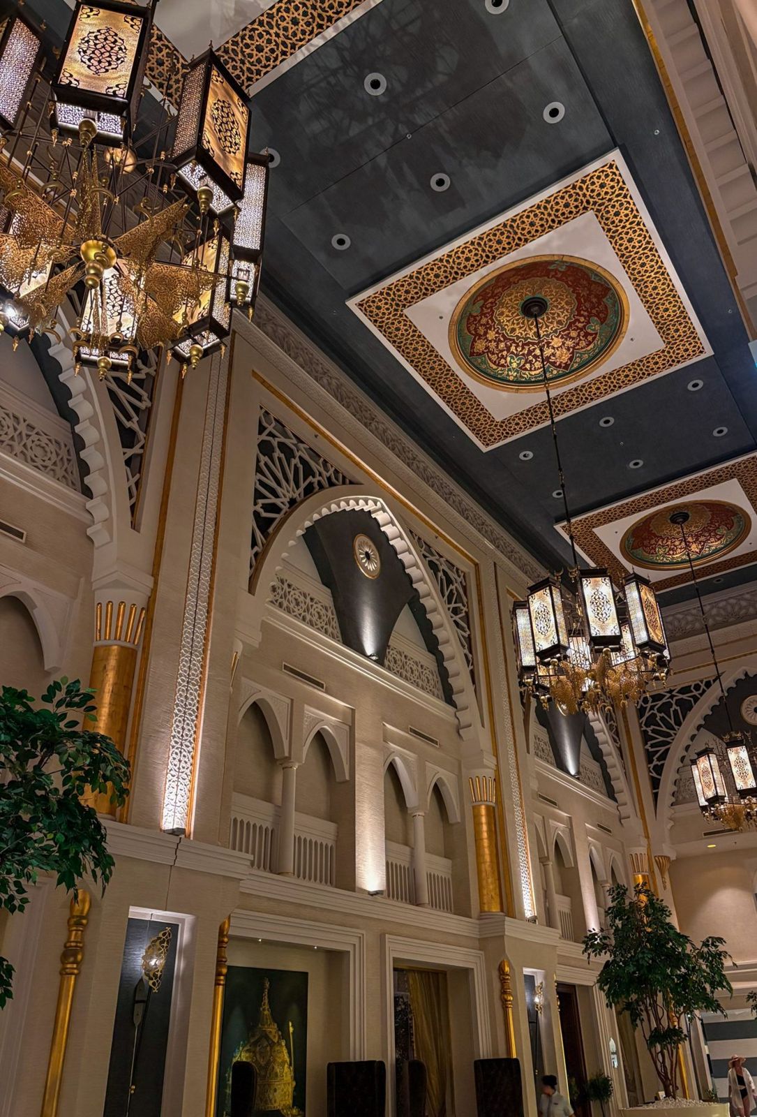 The Great Hall, with a carved ceiling and chandeliers